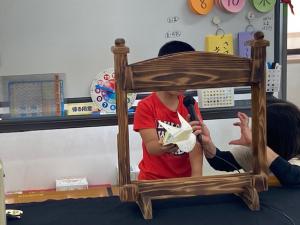パクパク人形を使って腹話術を披露する小学生の様子の写真