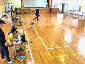 中学生が作成した目標物を目指してプログラミングしドローンを飛ばす様子