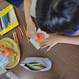 夏野菜を描く子供の様子