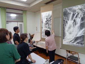 朝もらに包まれた温泉街の説明をされる講師