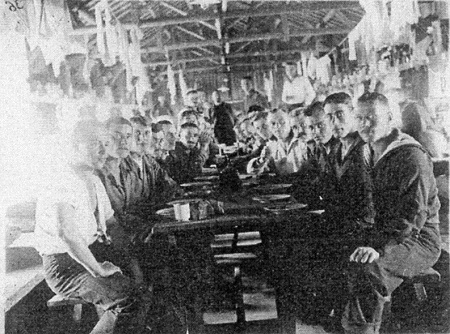 image: Prisoners having a meal at the camp