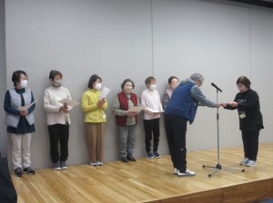 舞台にあがり一人ずつ皆勤賞を授与されている講座生